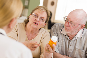 Image showing Doctor or Nurse Explaining Prescription Medicine to Senior Coupl