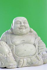 Image showing A buddha figurine against a green background