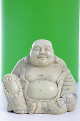 Image showing A buddha figurine against a green background