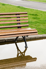 Image showing A bench and reflection in the park after the rain