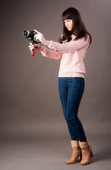 Image showing young woman with video camera