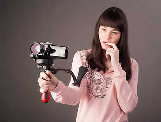 Image showing young woman with video camera