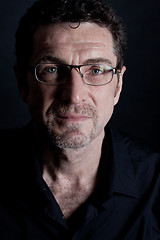 Image showing attractive adult man with glasses on black background