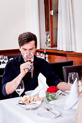 Image showing couple drinking red wine in restaurant