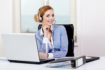 Image showing smiling young female callcenter agent with headset