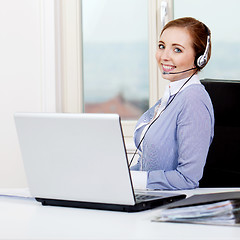 Image showing smiling young female callcenter agent with headset