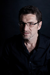 Image showing attractive adult man with glasses on black background