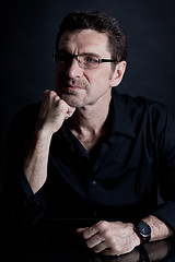 Image showing attractive adult man with glasses on black background