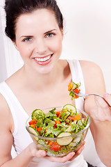 Image showing smiling woman eating fresh salad