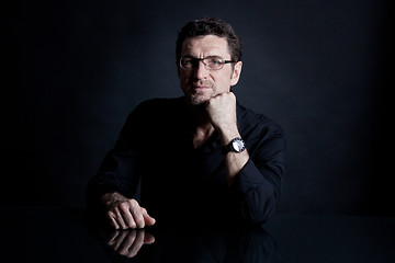 Image showing attractive adult man with glasses on black background