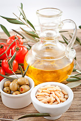 Image showing tatsty geen olives tomatoes and olive oil 