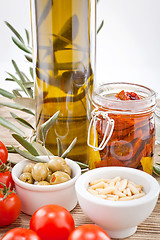 Image showing tatsty geen olives tomatoes and olive oil 