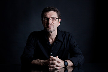 Image showing attractive adult man with glasses on black background