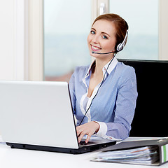 Image showing smiling young female callcenter agent with headset