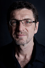 Image showing attractive adult man with glasses on black background