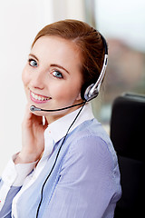 Image showing smiling young female callcenter agent with headset