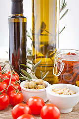 Image showing tatsty geen olives tomatoes and olive oil 