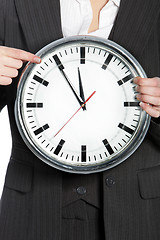 Image showing Woman holding a clock