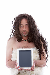 Image showing Funny primitive man holding a PC tablet