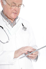 Image showing Senior doctor working on a tablet