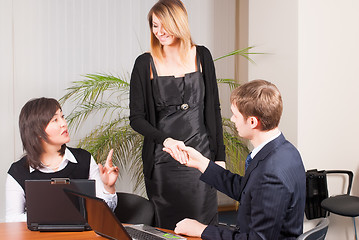 Image showing businessman congratulate young businesswoman