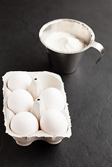 Image showing Eggs and cup of flour