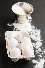 Image showing Eggs and cup of flour