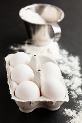 Image showing Eggs and cup of flour