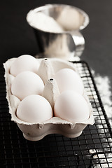 Image showing Eggs and cup of flour