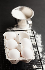 Image showing Eggs and cup of flour