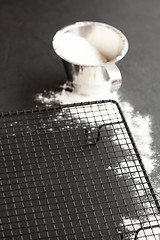 Image showing Cup of flour and mesh tray