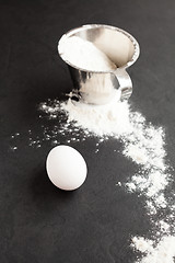 Image showing Egg and cup of flour