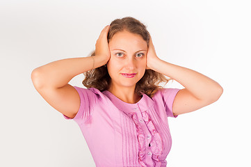 Image showing Hear no evil - Young woman covering her ears