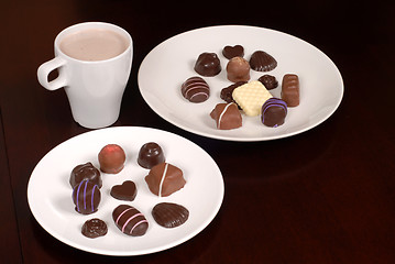 Image showing Two plates of chocolates with a cup of hot chocolate