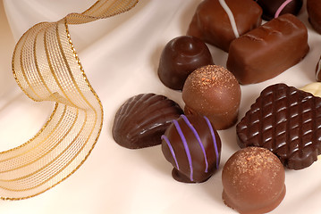 Image showing Several pieces of semi-sweet and bittersweet chocolate on beige