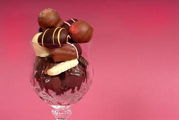 Image showing Dark and semi-sweet chocolates in a cut crystal wine glass