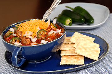 Image showing Bowl of spicey chili and crackers with jalapeno peppers