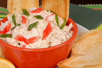 Image showing Closeup of a bowl of crab dip with toasted crostini and lemon