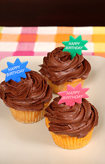 Image showing Three chocolate frosted cupcakes with 