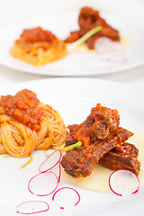 Image showing pasta with pork ribs sauce on polenta bed