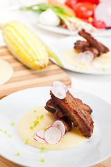 Image showing pork ribs on polenta corn cream bed
