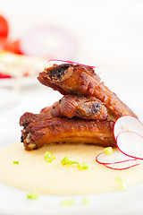 Image showing pork ribs on polenta corn cream bed