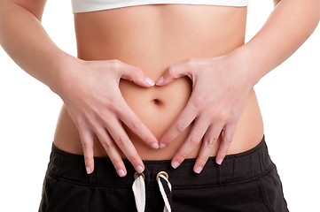 Image showing Woman Making a Heart Symbol over her Tummy