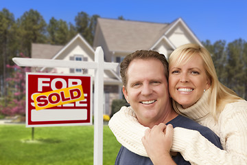 Image showing Couple in Front of Sold Real Estate Sign and House