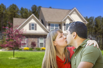 Image showing Mixed Race Couple Hugging in Front of House