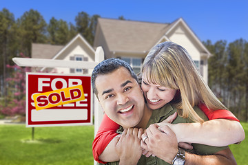 Image showing Couple in Front of Sold Real Estate Sign and House