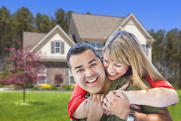 Image showing Mixed Race Couple Hugging in Front of House