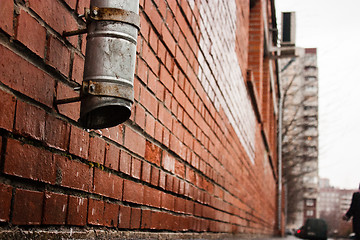 Image showing black tube on a brick house wall (drain water)