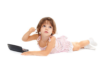 Image showing Cute little girl is applying mascara