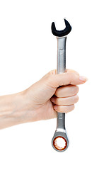 Image showing Woman's hand holding a chrome wrench.